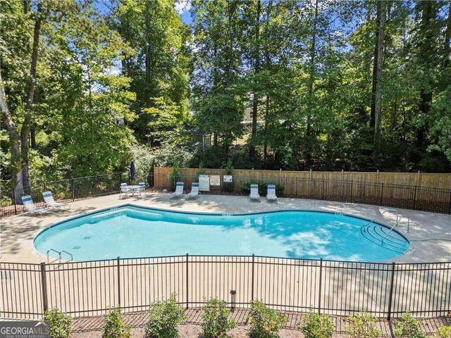 view of swimming pool featuring a patio