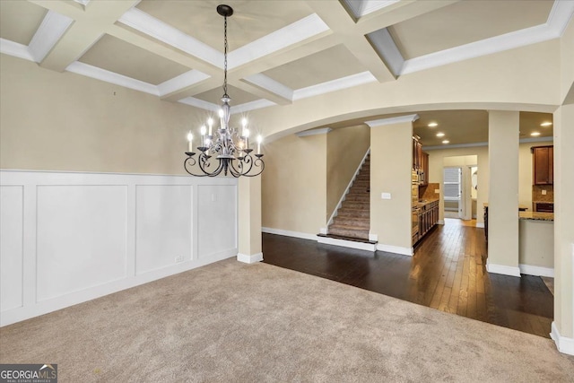 unfurnished dining area with dark hardwood / wood-style flooring, beamed ceiling, crown molding, and coffered ceiling