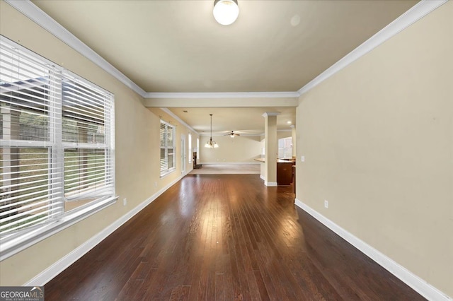 interior space with crown molding, a healthy amount of sunlight, and dark hardwood / wood-style floors