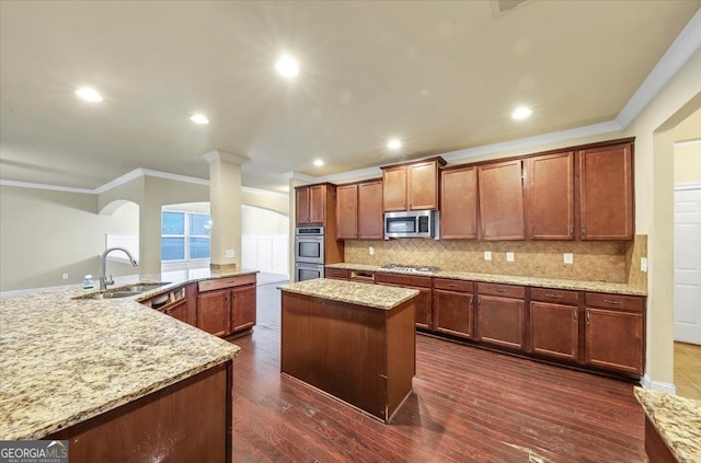 kitchen with dark hardwood / wood-style flooring, sink, light stone counters, and appliances with stainless steel finishes