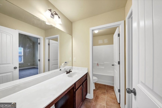 bathroom with tile patterned flooring, vanity, and toilet