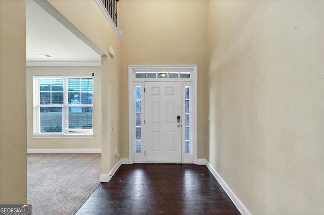 foyer featuring dark hardwood / wood-style floors and ornamental molding