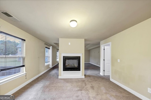 unfurnished living room featuring light colored carpet