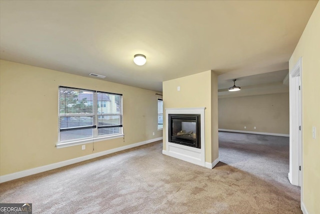 unfurnished living room featuring light colored carpet