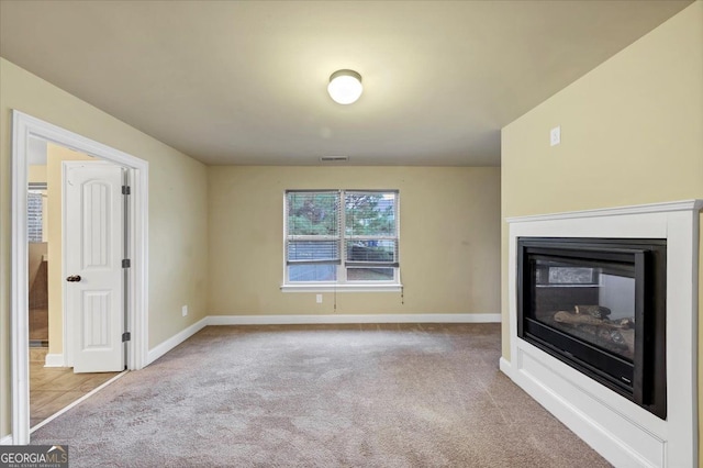 unfurnished living room with light colored carpet