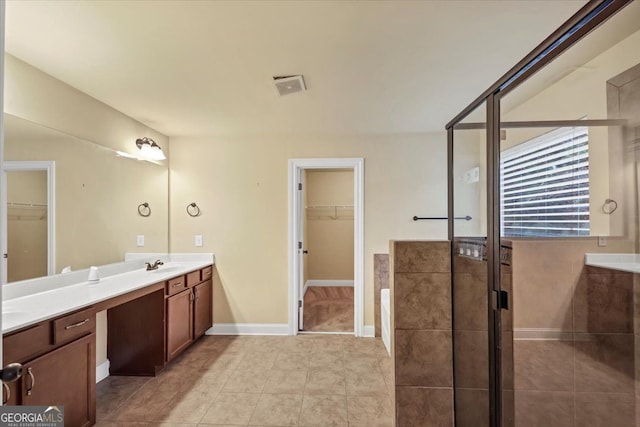 bathroom featuring an enclosed shower, vanity, and tile patterned floors