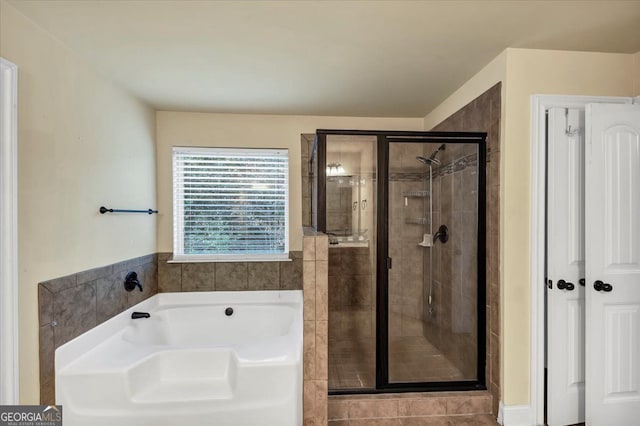 bathroom featuring shower with separate bathtub