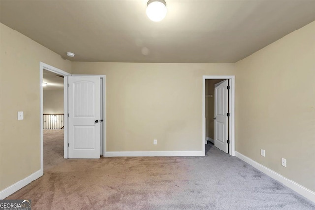 unfurnished bedroom featuring light carpet