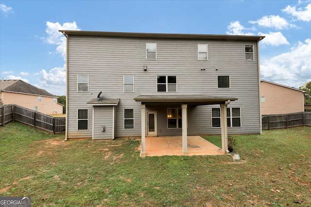 rear view of house with a patio and a lawn