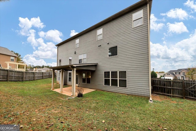 back of house featuring a yard and a patio