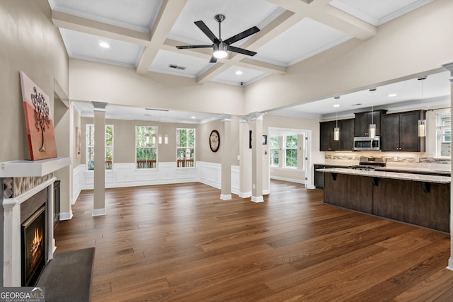 living room featuring dark hardwood / wood-style floors, crown molding, ceiling fan, and a healthy amount of sunlight