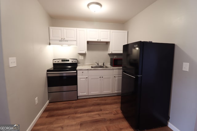 kitchen with black appliances, dark hardwood / wood-style flooring, sink, and white cabinets