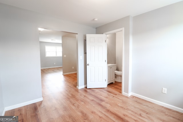 unfurnished room with light wood-type flooring