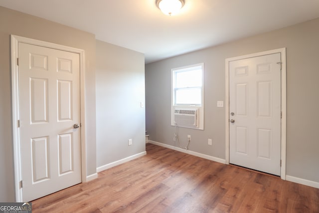 entryway with cooling unit and light hardwood / wood-style flooring