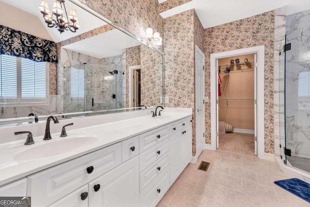 bathroom with walk in shower, vanity, and tile patterned floors