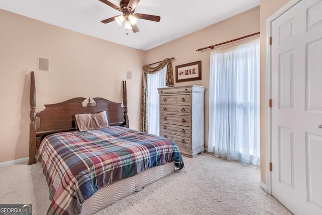 bedroom featuring light colored carpet and ceiling fan