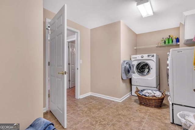 clothes washing area featuring light tile patterned floors and independent washer and dryer