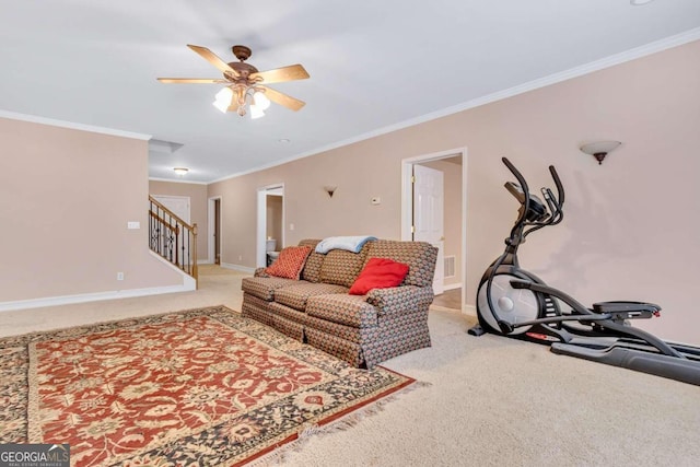 carpeted living room with ceiling fan and crown molding