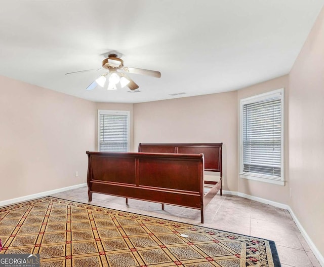 bedroom with tile patterned flooring and ceiling fan