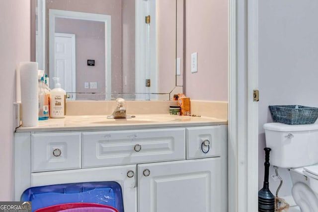 bathroom featuring vanity and toilet