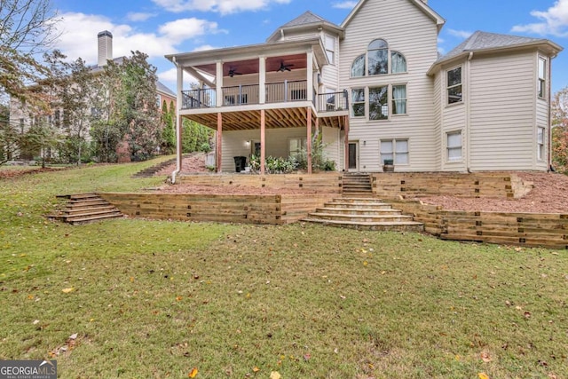 back of house with a lawn, ceiling fan, and a balcony