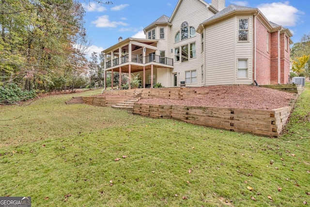 rear view of property with cooling unit, a lawn, and a balcony