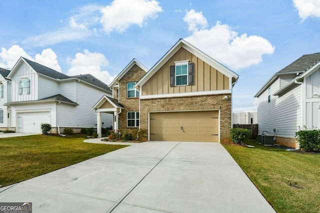 view of front facade with a front lawn, a garage, and central AC