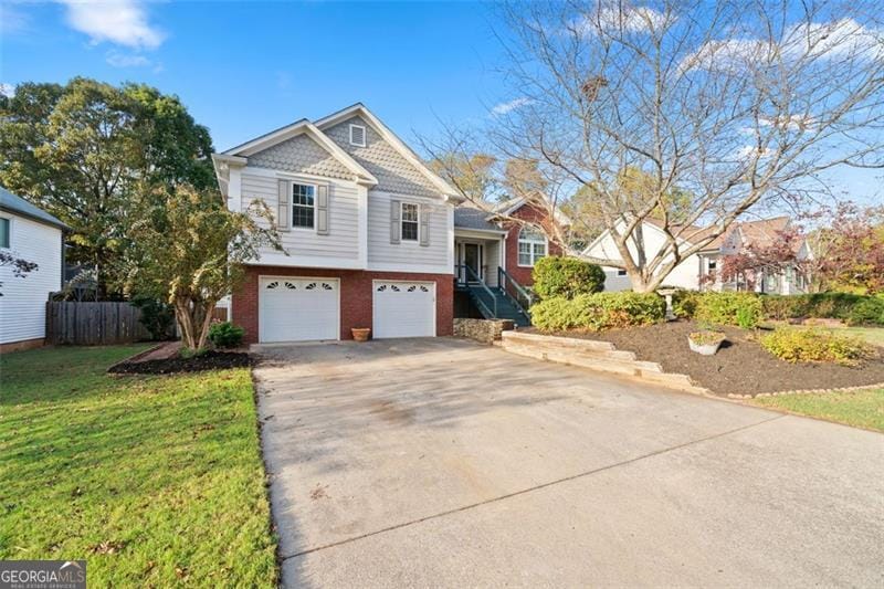 view of front of house with a front lawn and a garage