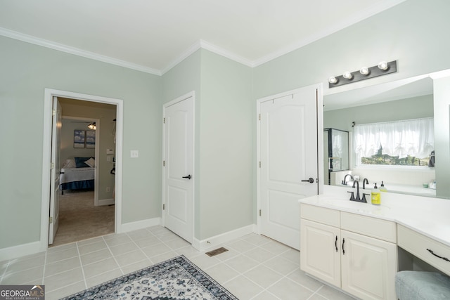 bathroom with crown molding, tile patterned flooring, and vanity