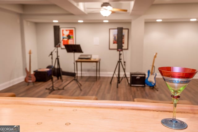 workout room with hardwood / wood-style floors and ceiling fan