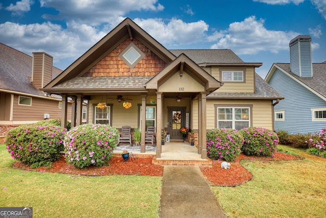 craftsman inspired home with a porch and a front yard