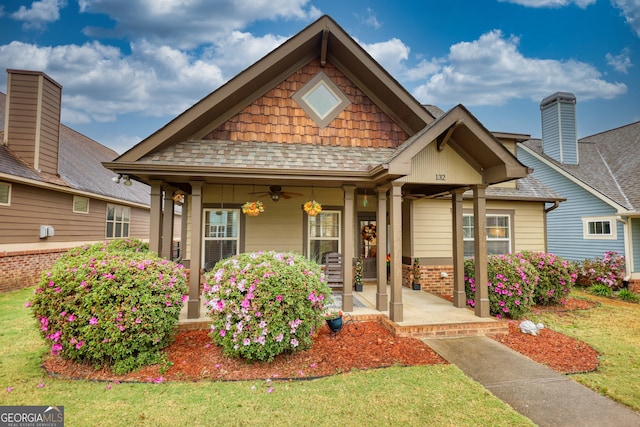 craftsman-style house featuring a porch and a front yard