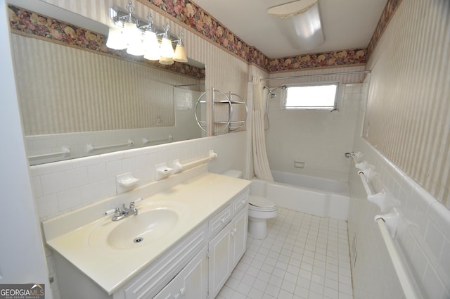 full bathroom featuring toilet, shower / bath combo with shower curtain, tile patterned floors, and vanity