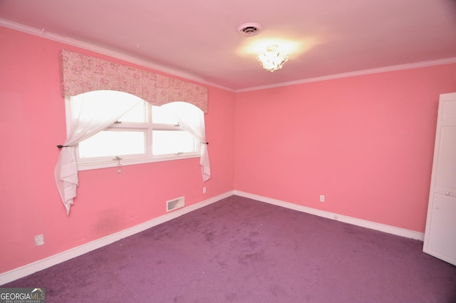 carpeted spare room with crown molding