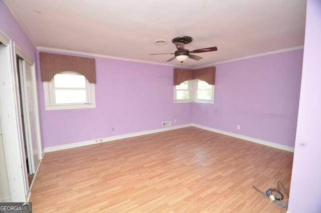 unfurnished room featuring ornamental molding, ceiling fan, light hardwood / wood-style floors, and plenty of natural light