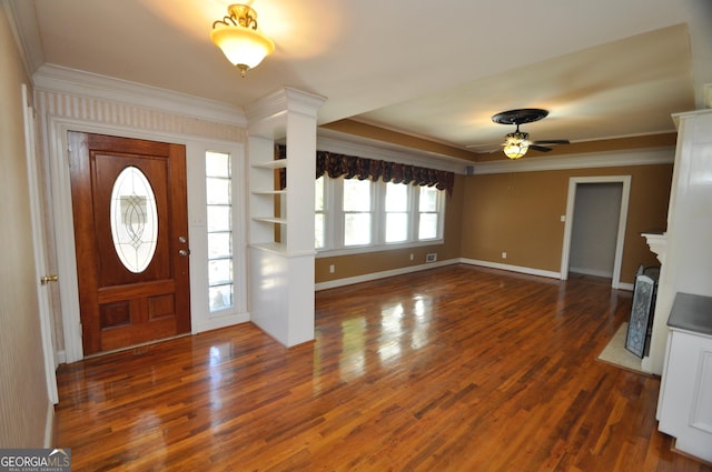 foyer entrance with ceiling fan, ornamental molding, and dark hardwood / wood-style floors