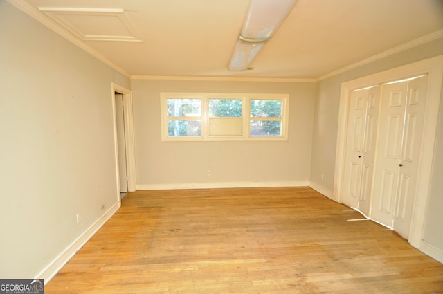 unfurnished bedroom with ornamental molding and light wood-type flooring