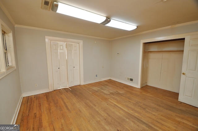 unfurnished bedroom featuring ornamental molding and wood-type flooring