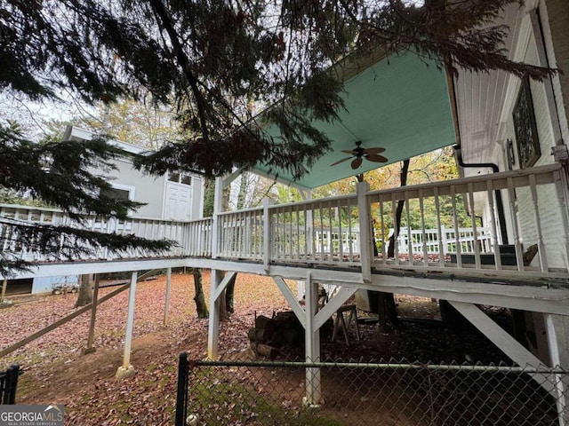 view of yard with ceiling fan and a wooden deck