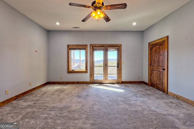 unfurnished room featuring carpet flooring and ceiling fan