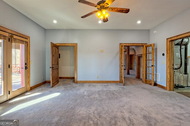 unfurnished bedroom featuring ceiling fan, light carpet, french doors, and access to outside