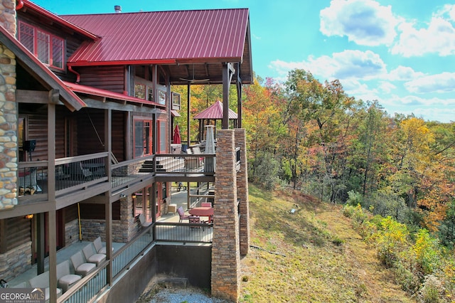 view of yard with a wooden deck and a balcony