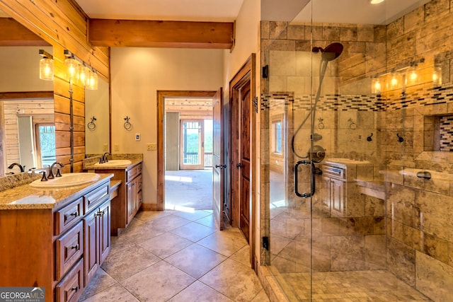 bathroom with beam ceiling, vanity, tile patterned flooring, and a shower with shower door