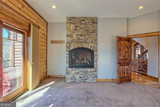 unfurnished living room with a fireplace and carpet flooring