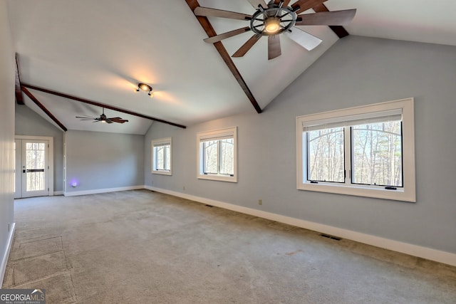 empty room featuring light colored carpet, ceiling fan, and vaulted ceiling