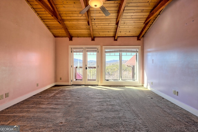 empty room featuring wooden ceiling, ceiling fan, carpet flooring, a mountain view, and lofted ceiling with beams