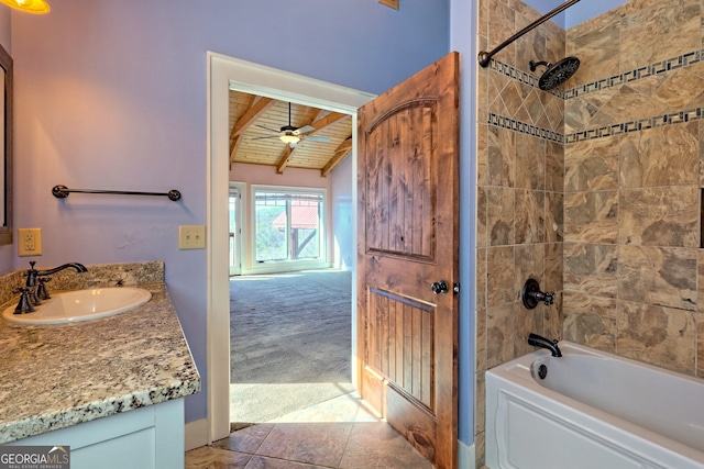 bathroom with lofted ceiling with beams, vanity, tiled shower / bath combo, wood ceiling, and ceiling fan