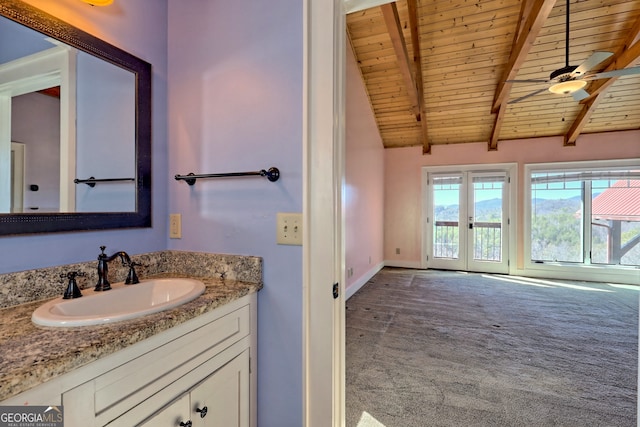 bathroom with ceiling fan, vanity, wood ceiling, vaulted ceiling with beams, and french doors