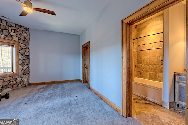 carpeted empty room featuring ceiling fan