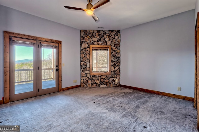 unfurnished room featuring carpet and ceiling fan